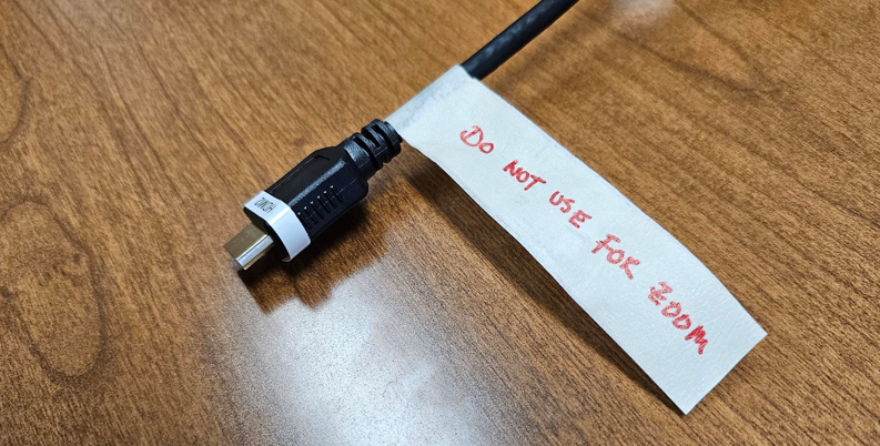 HDMI cable with a label that says do not use for zoom