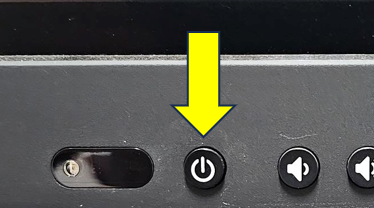 A yellow arrow pointing downward at an picture of the power button on the display monitor.